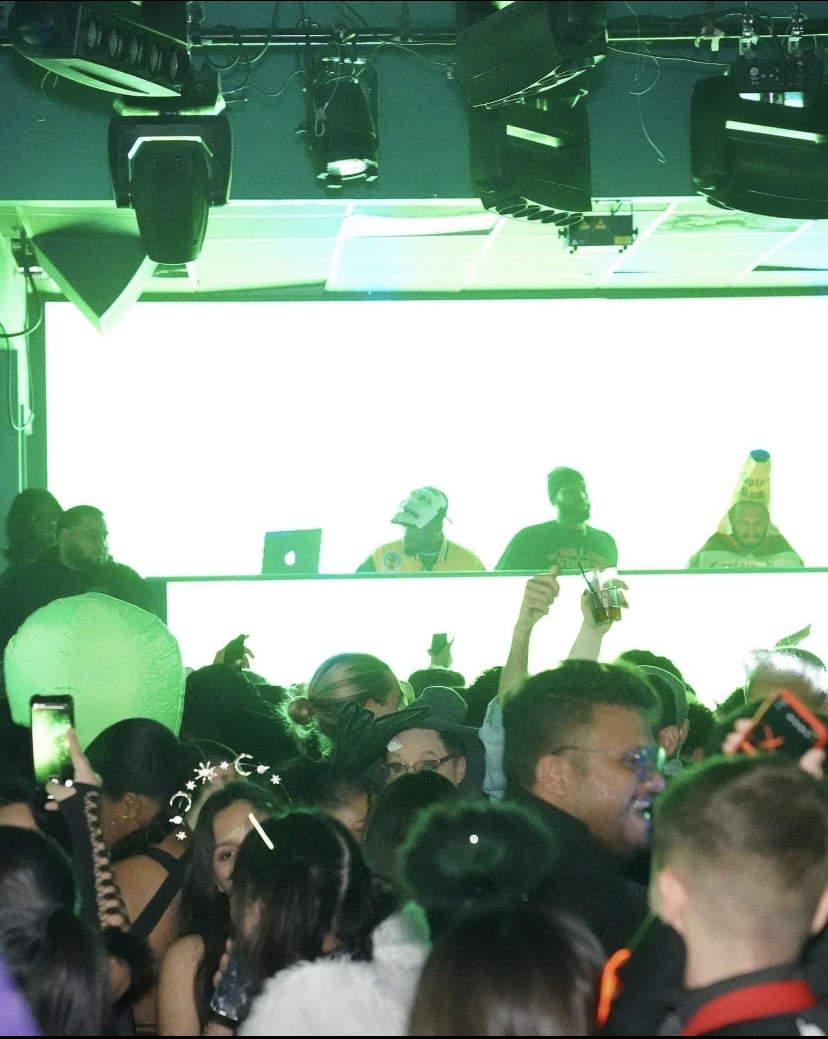Club atmosphere with crowd and DJ booth